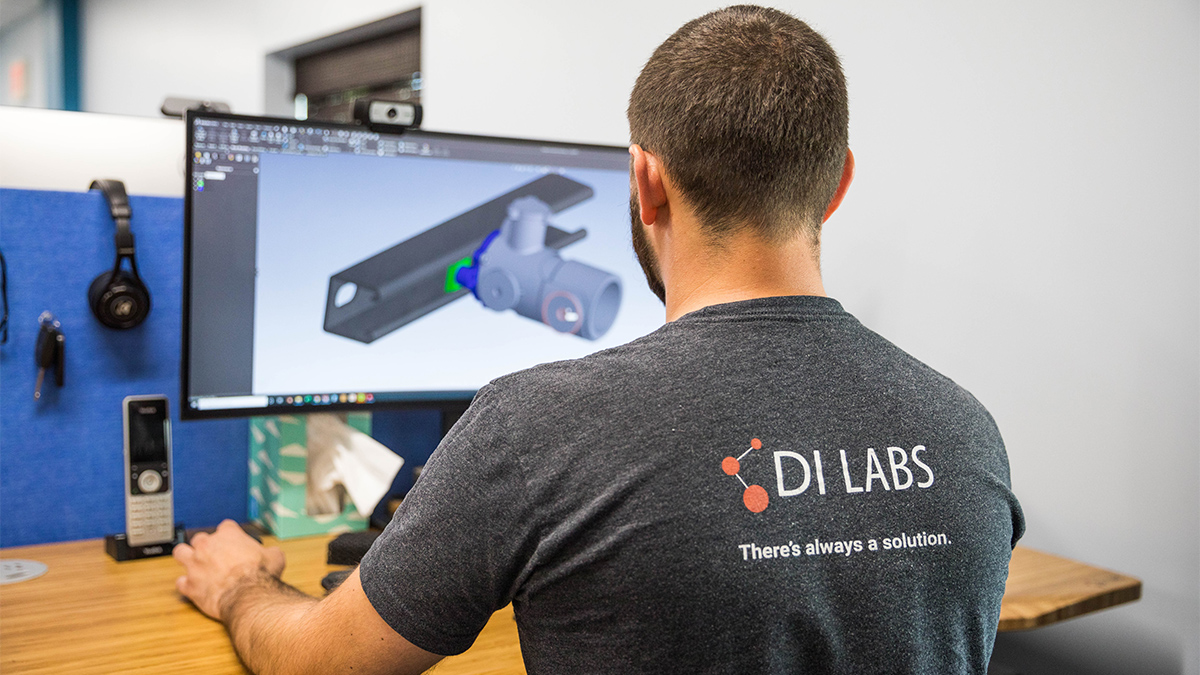 A DI Labs engineer reviewing a client's 3D part model on screen during engineering review.